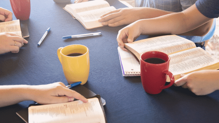 Table with coffee mugs, pens, Bibles and notebooks on the table. Church Equip How to Lead a Healthy Small Group Church Equip Curriculum