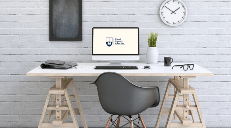 Desk, computer, char. Church Answers University